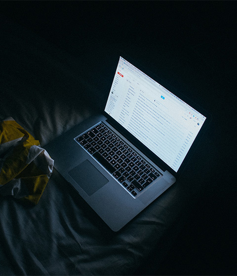 picture of glaring laptop in dark bedroom